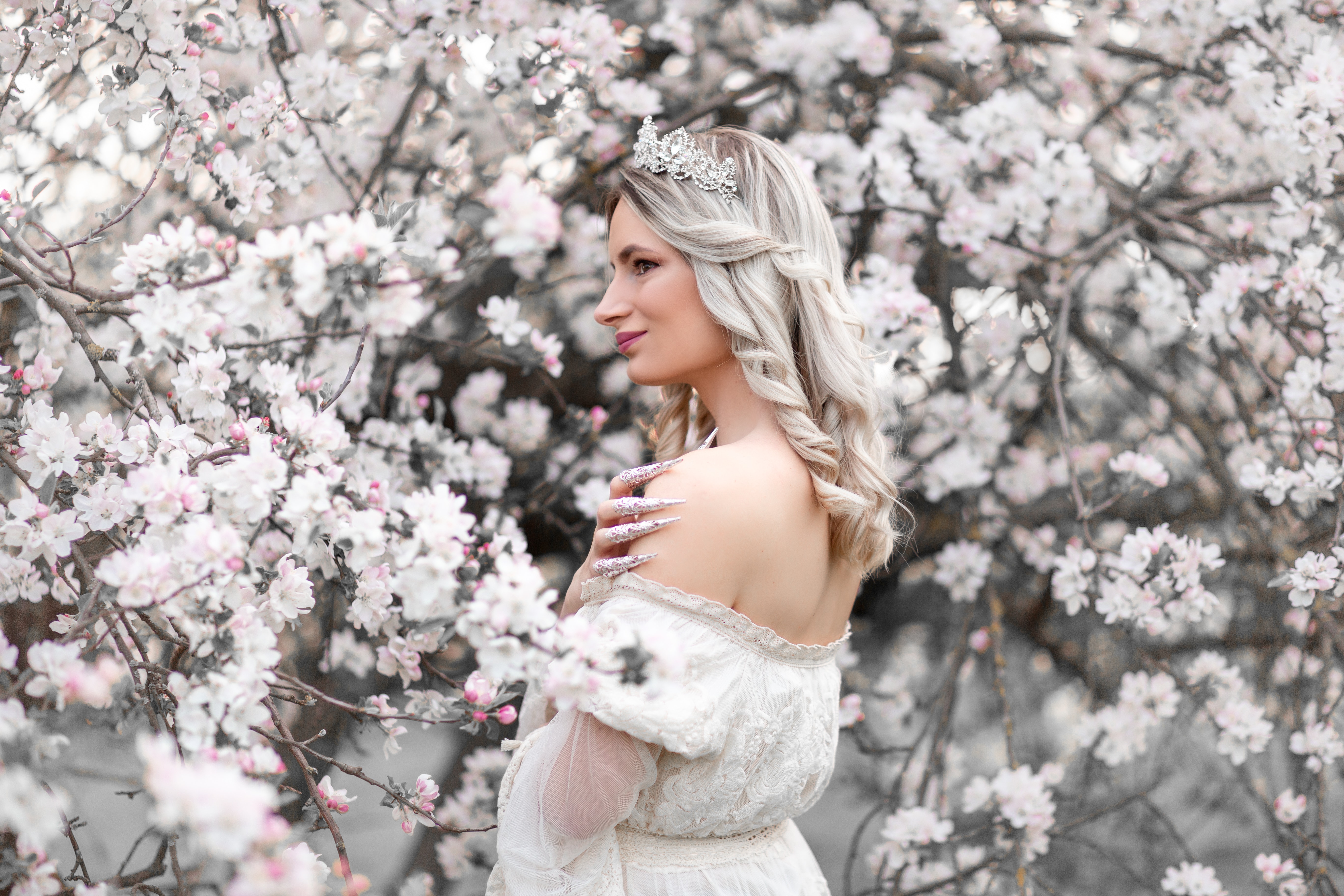 beautiful white princess enjoying blooming tree