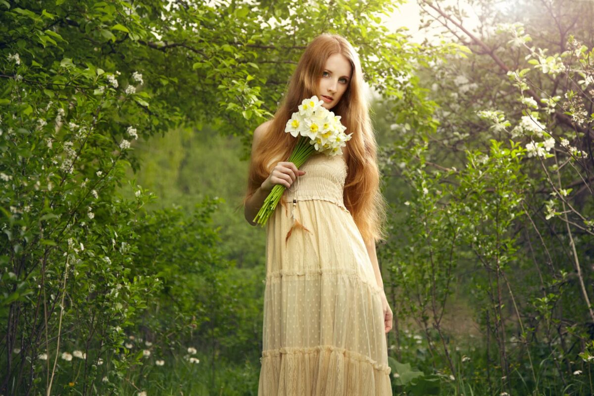 a beautiful fairy woman with flowers in the garden