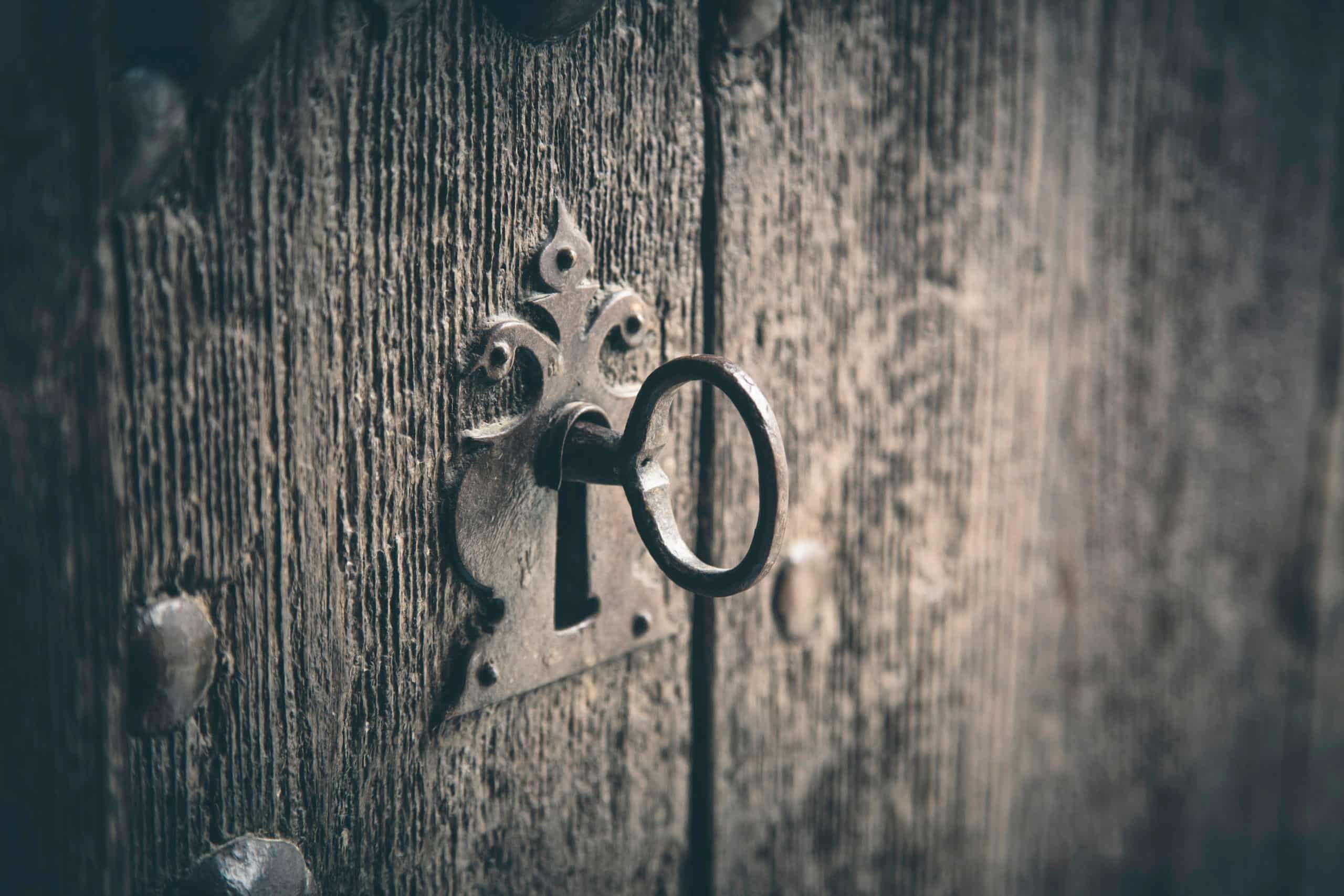 Rustic wooden door with old key.