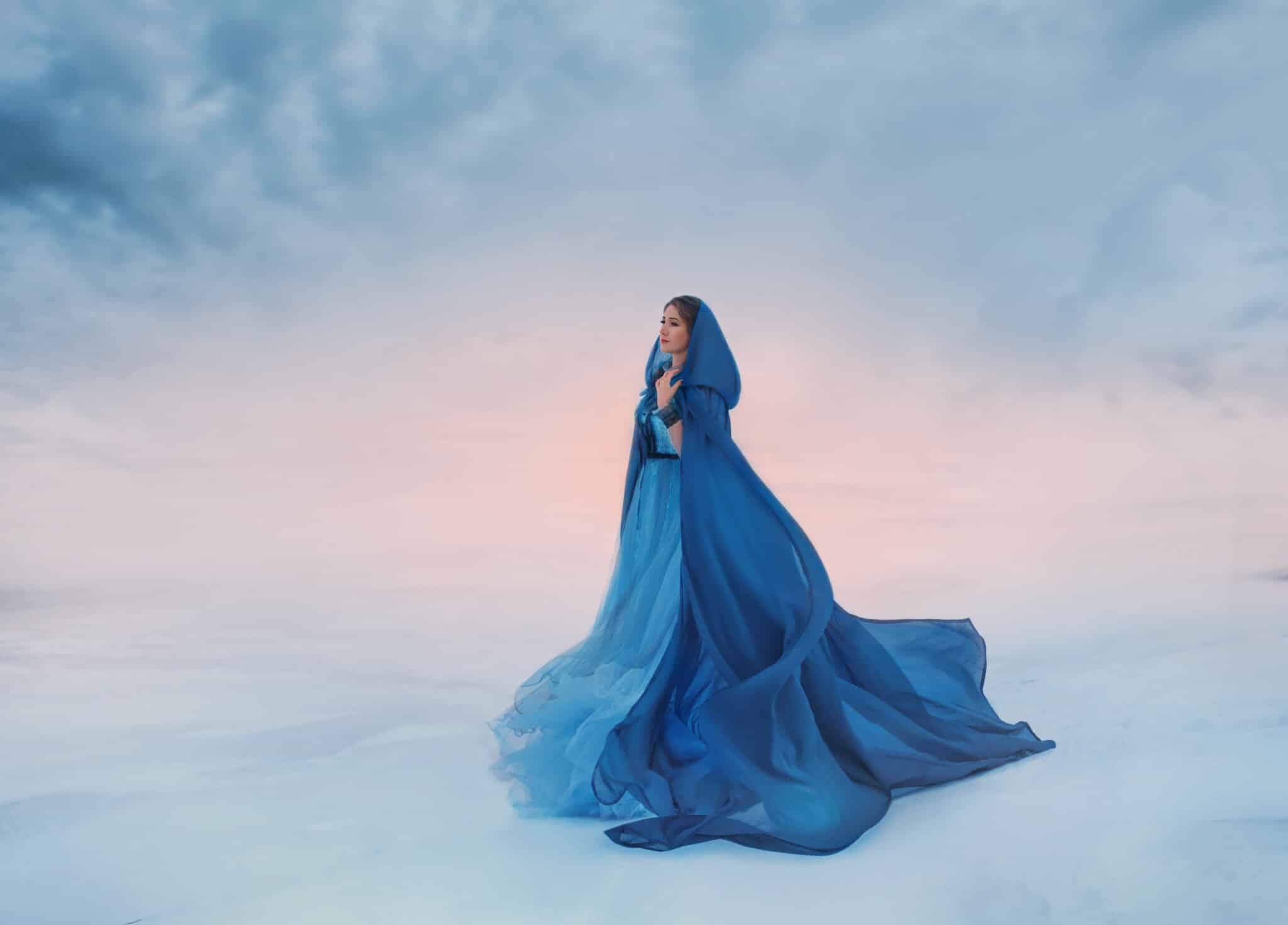 The Snow Queen in a blue raincoat that flutters in the wind.