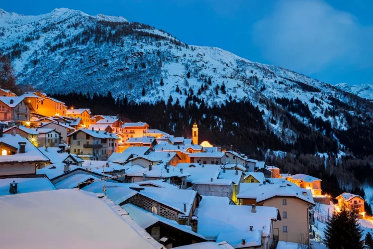 snowy village with lights  in the Alps 