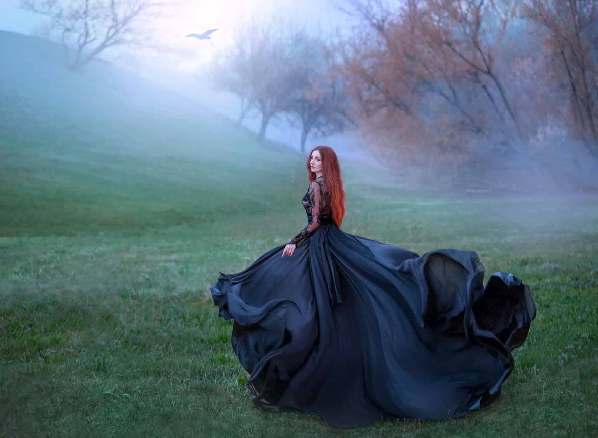 mysterious red-haired lady runs in the forest in gorgeous black royal dress