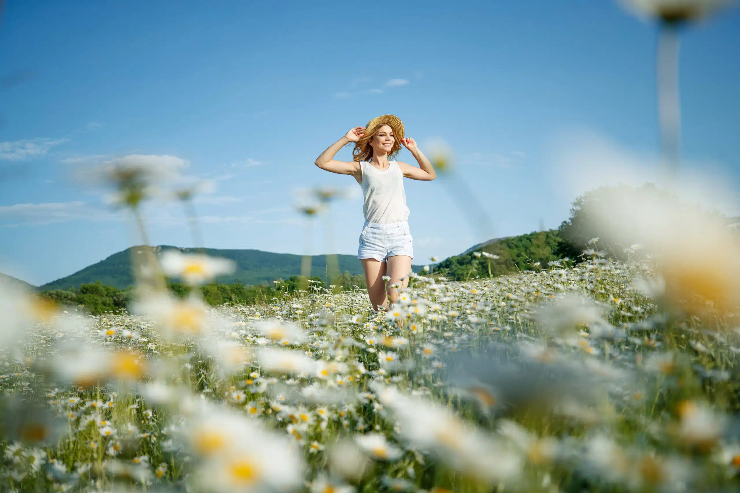 Beautiful woman in the field with flowers.