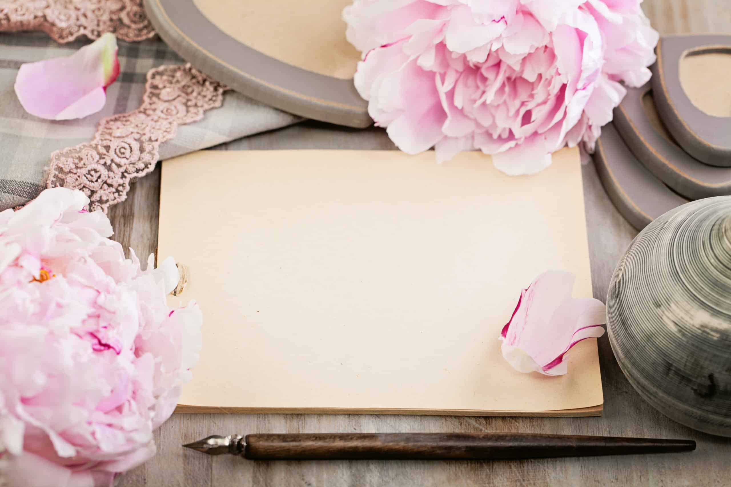 Empty blank paper on retro background with peony flowers.