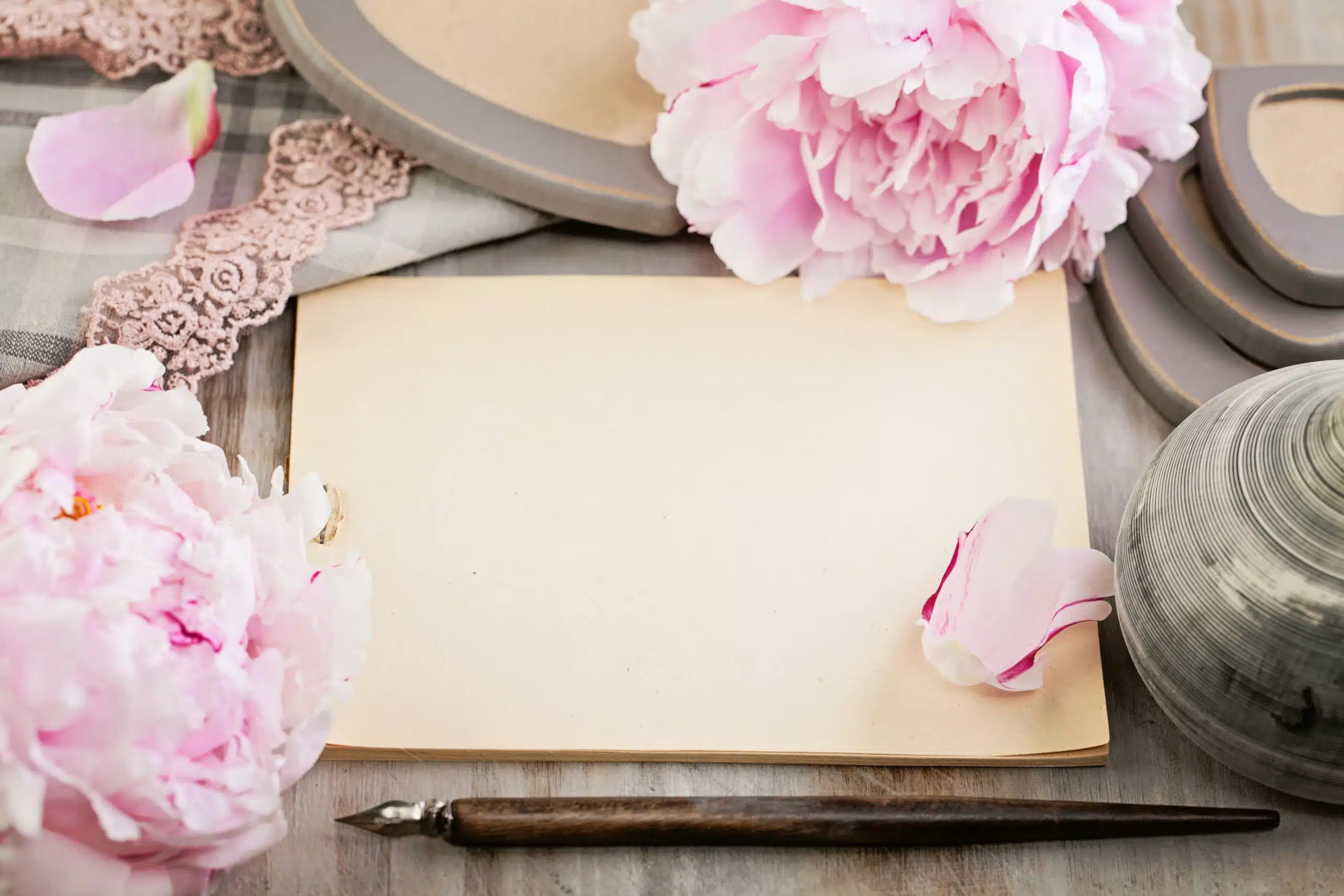 Empty blank paper on retro background with peony flowers.