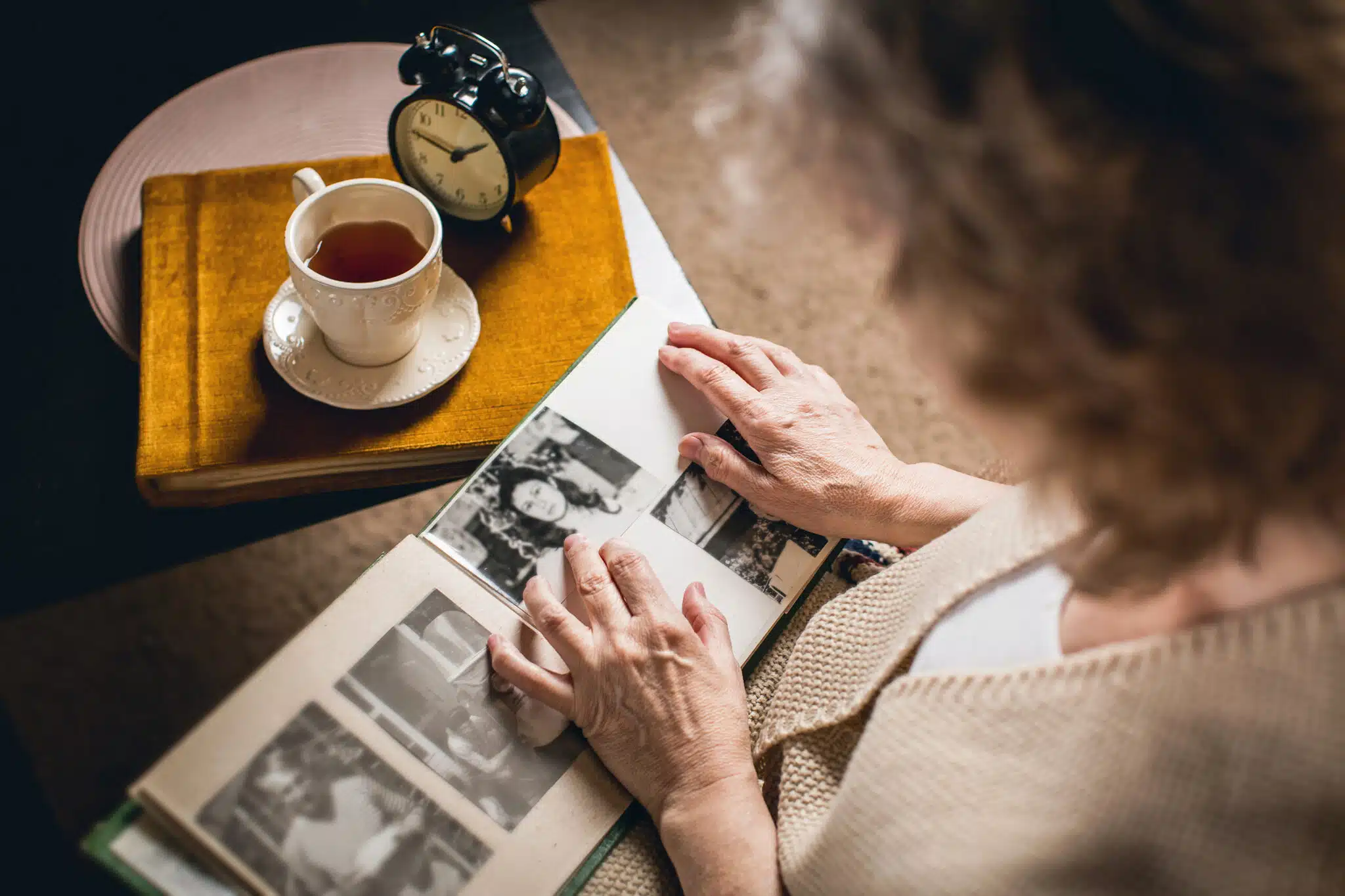 an elderly woman looks at your picture in the album