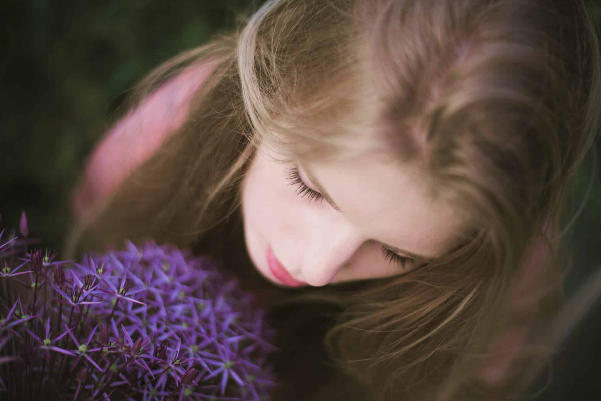a girl among purple wildflowers in evening