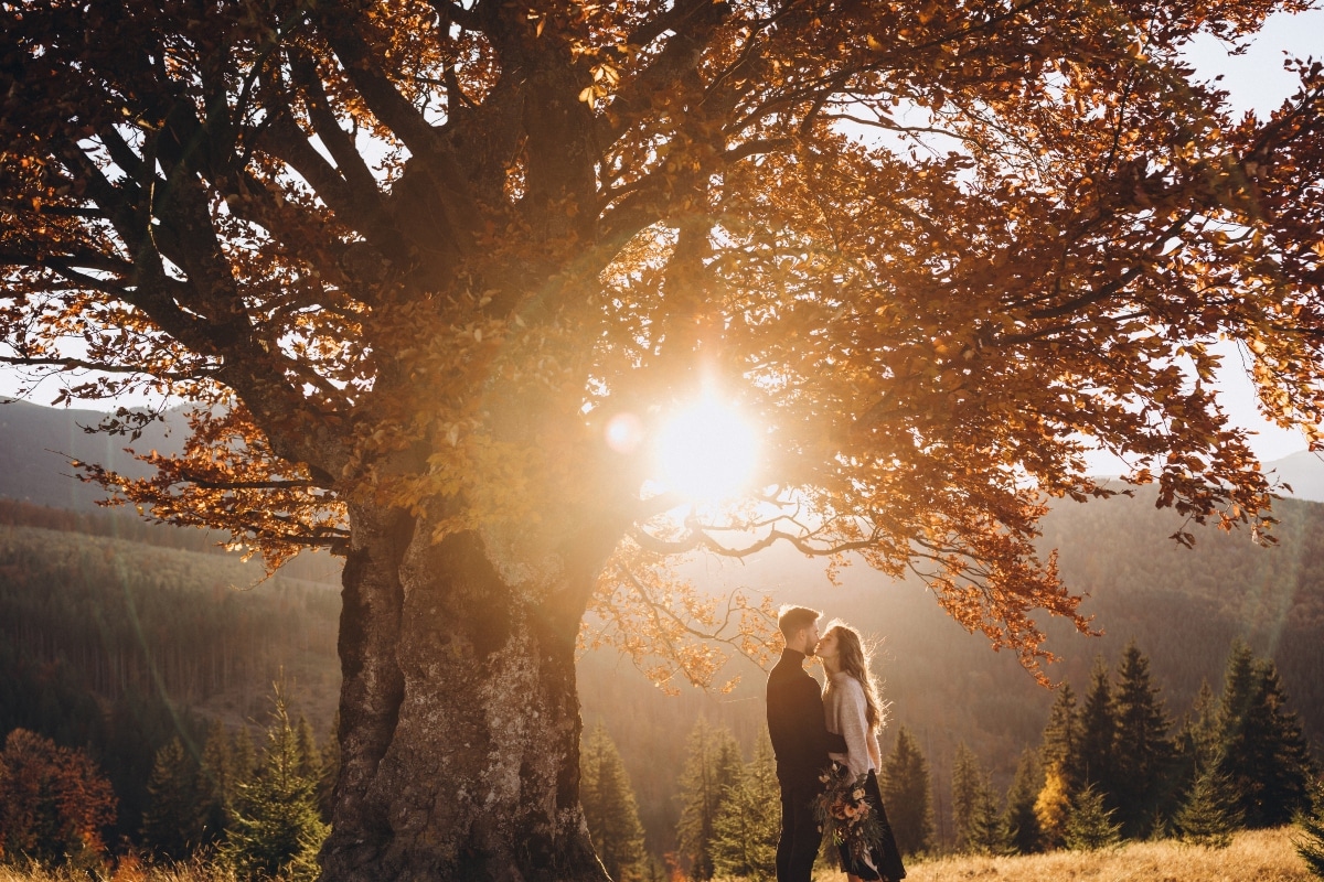 Stylish young couple in the autumn mountains. 