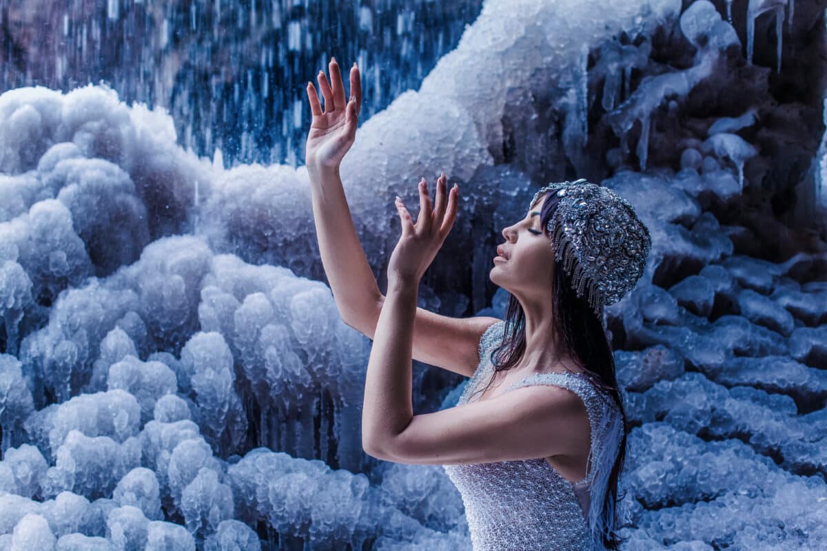 Beautiful woman with frozen icefall