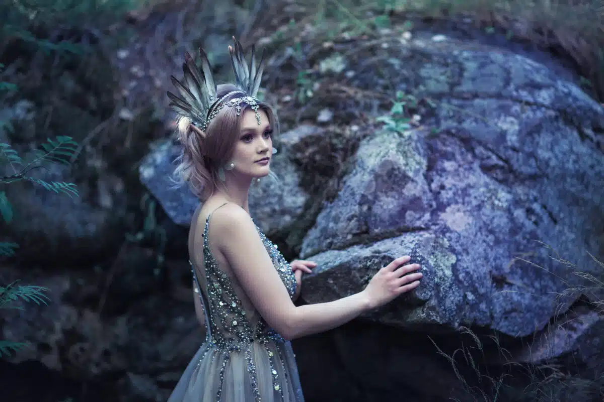 Fairytale girl in beautiful stones. Stones in the moss.