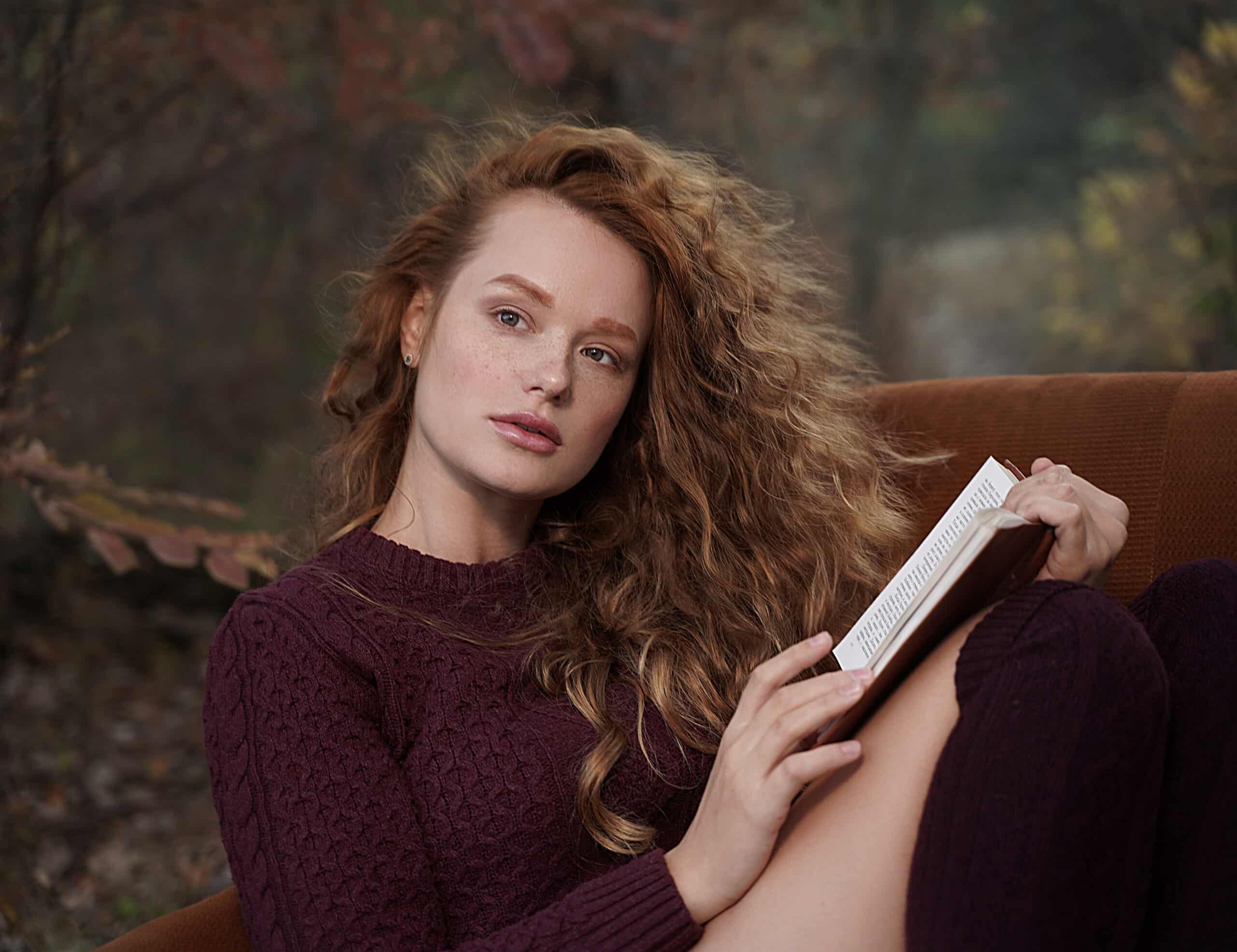 beautiful young red-haired woman with a book