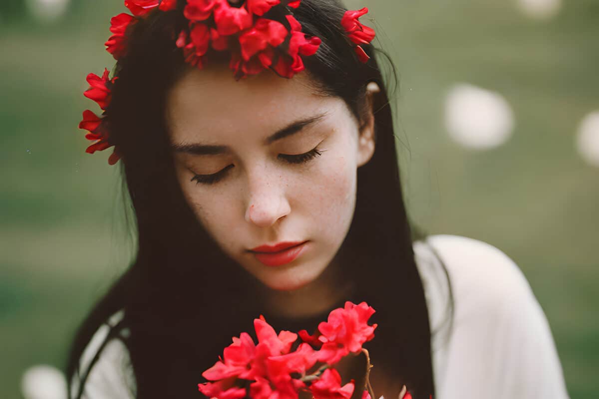 a pretty brunette woman with red flowers