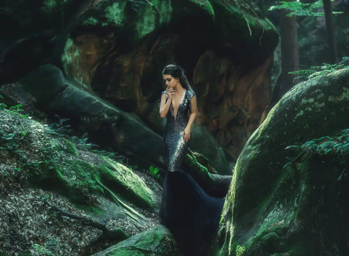 A young mysterious girl - a dark princess walks among the rocks.