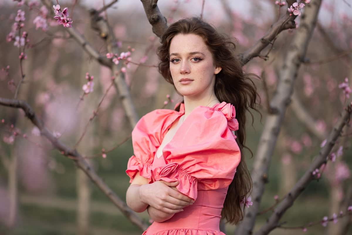 a beautiful lady in pink dress enjoying the blooming spring
