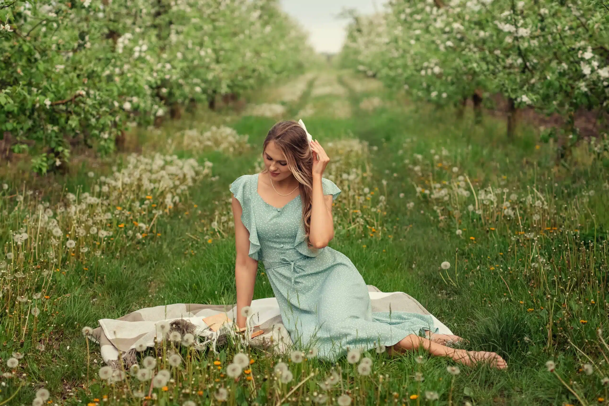 beautiful young woman in a romantic dress on a picnic in spring