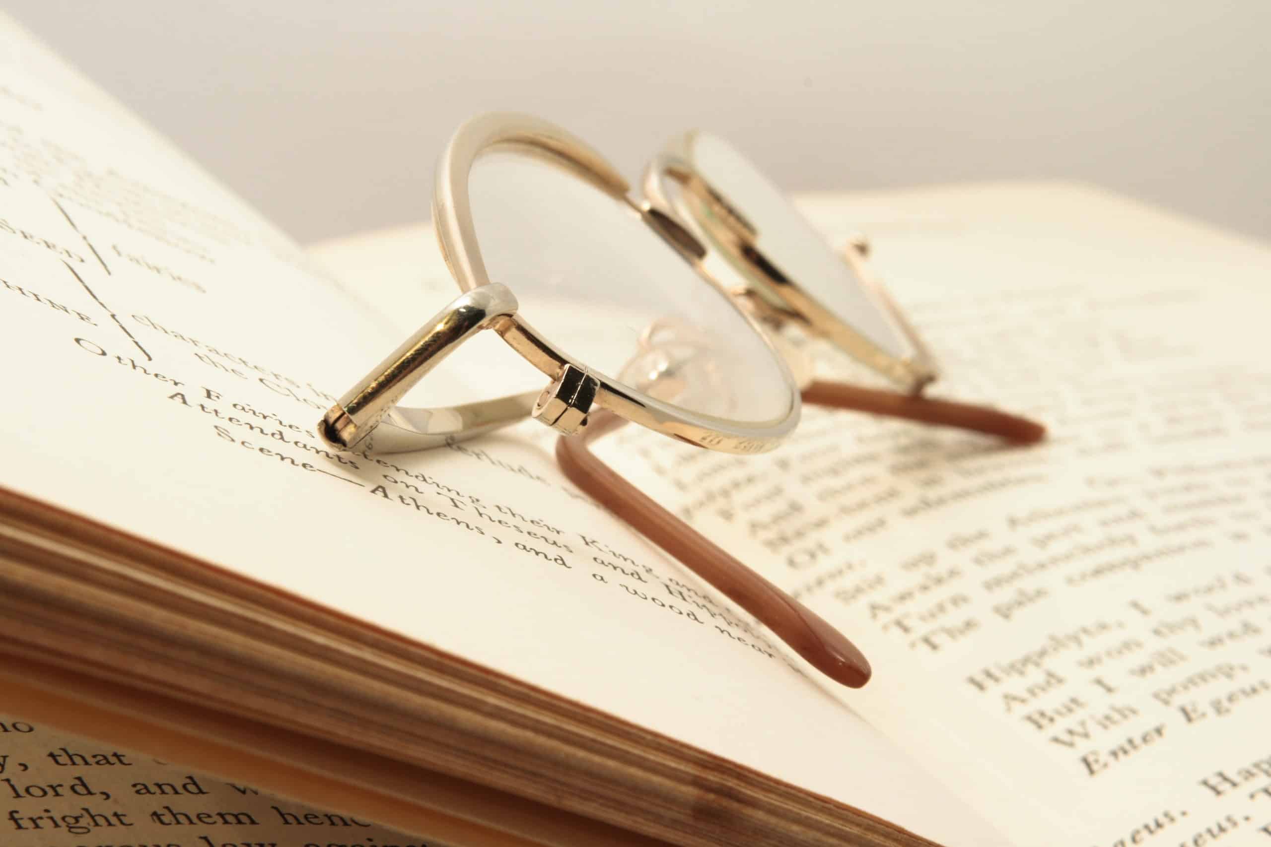 Open book and brown glasses