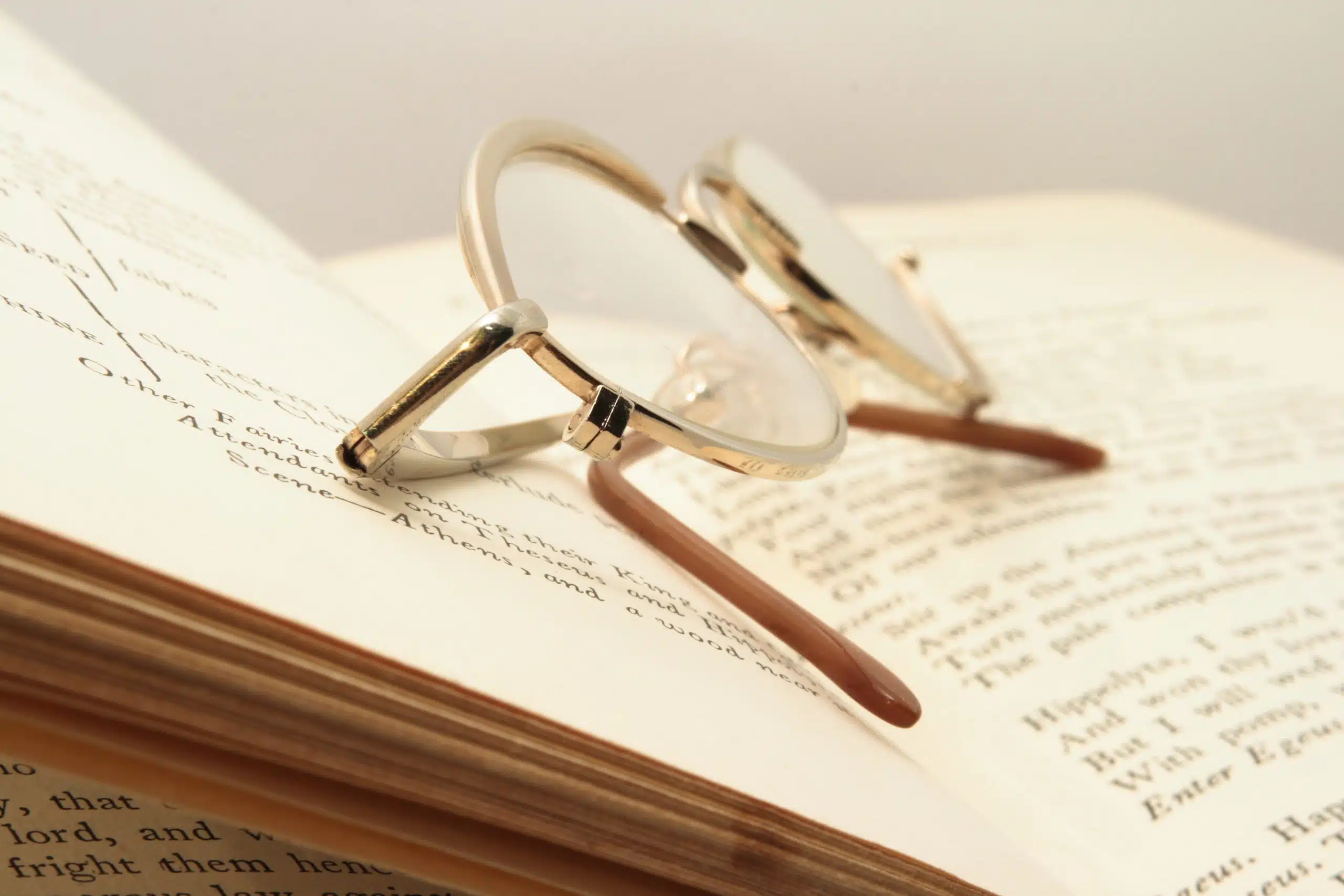 Open book and brown glasses