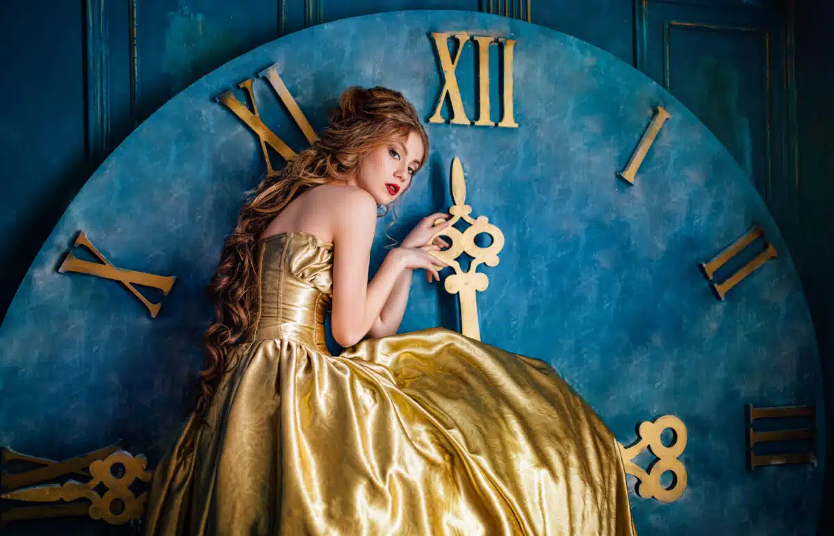 fairytale woman in a ball gown clings to a giant clock on the wall