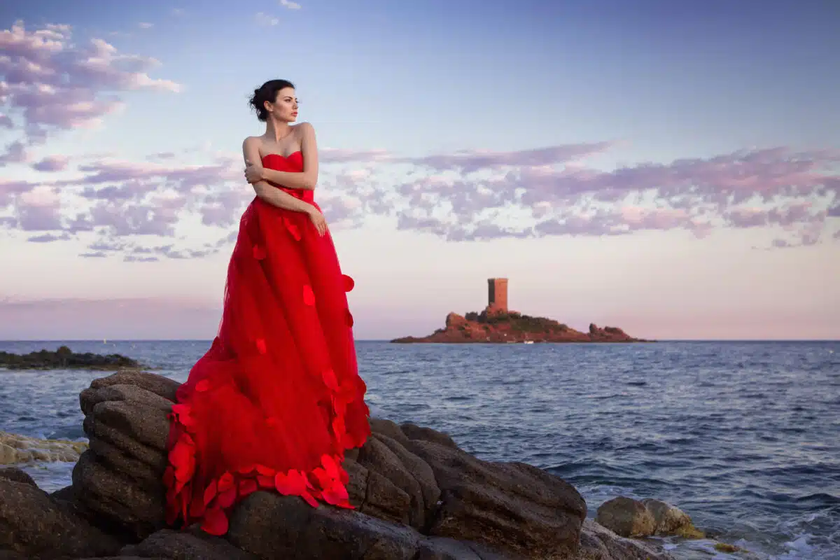 Junge Frau im schönen roten Fashion Kleid am Meer in St. Raphael Frankreich