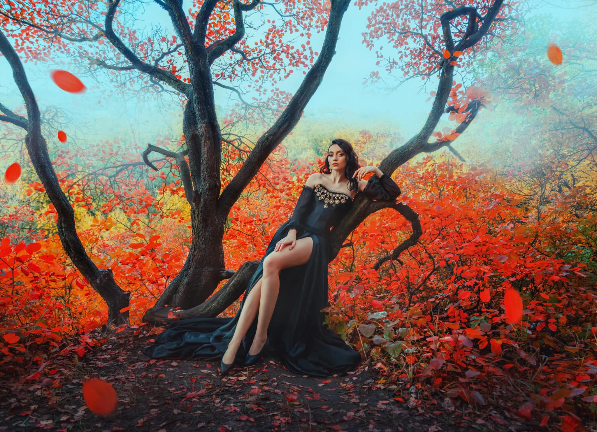 Fantasy woman dark queen sitting on tree branch autumn magic forest.