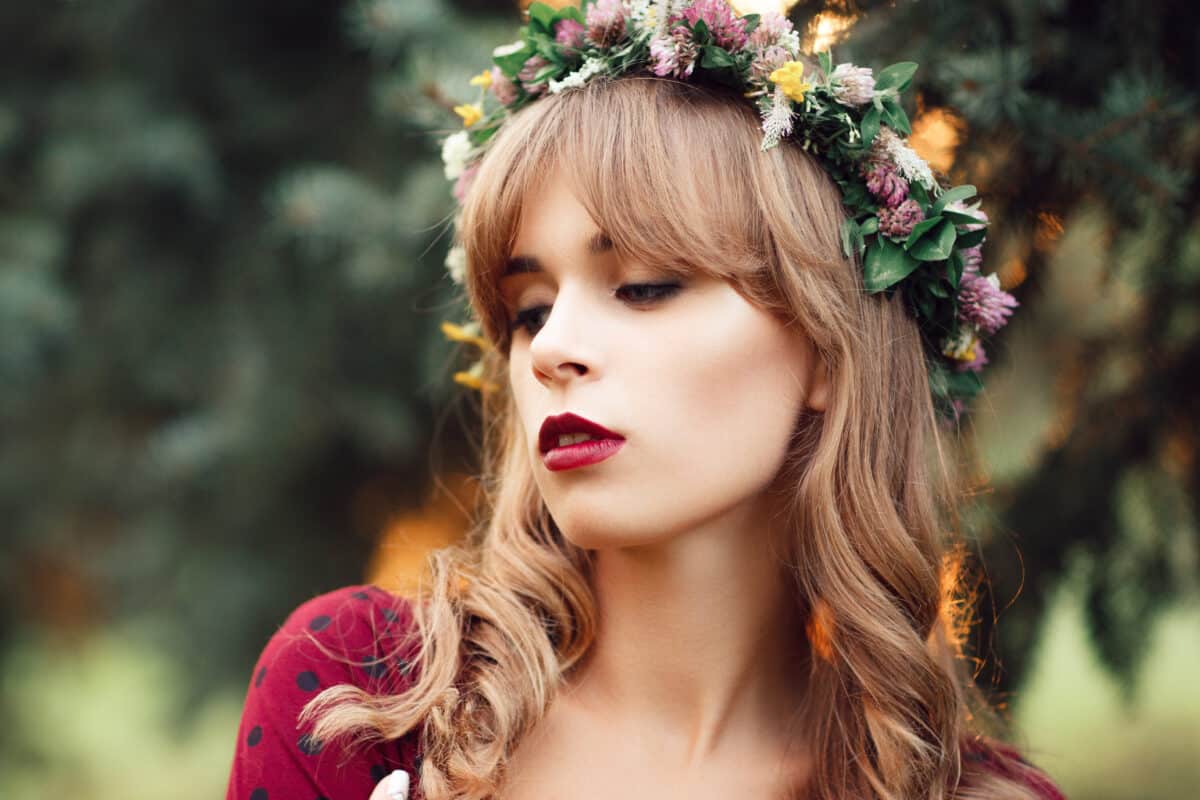 a beautiful blonde wearing a flower head wreath outdoor