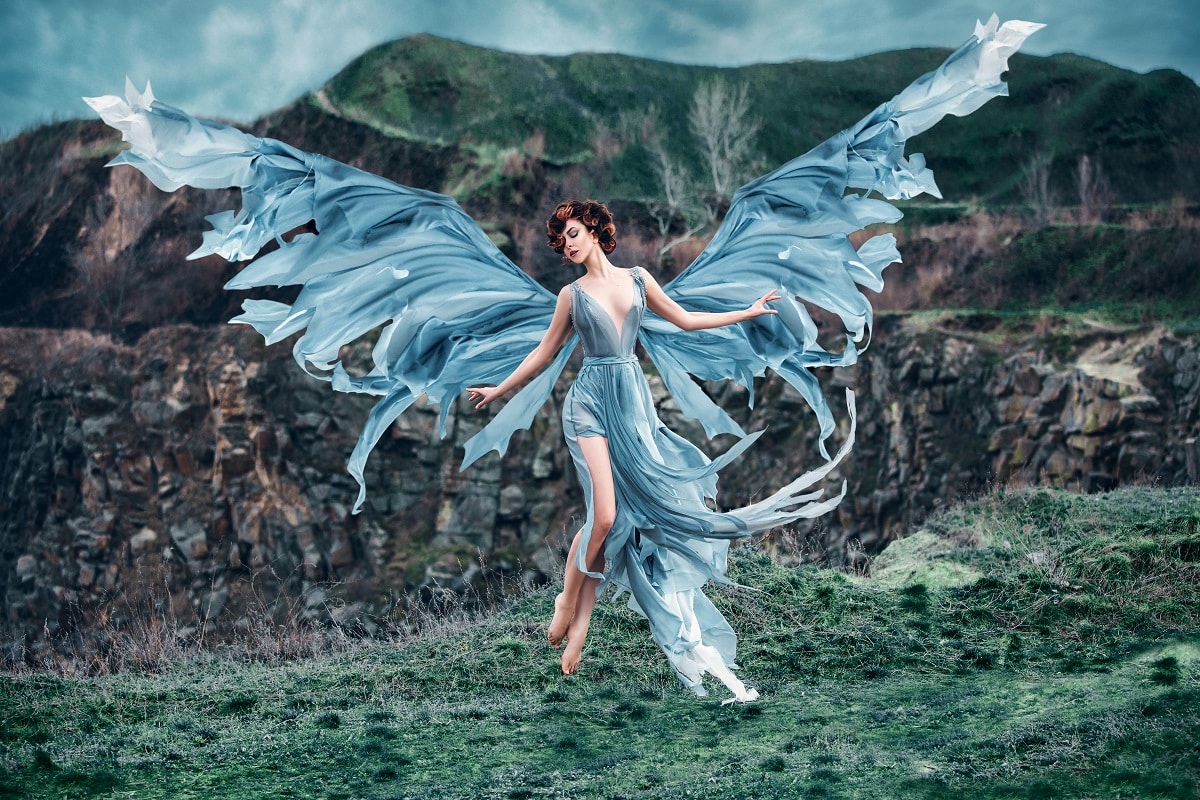 Girl angel with beautiful wings fly floating soaring in air