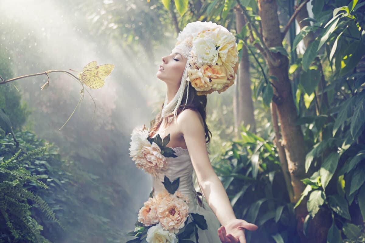 a fairytale exotic woman in flower dress looking up in prayer