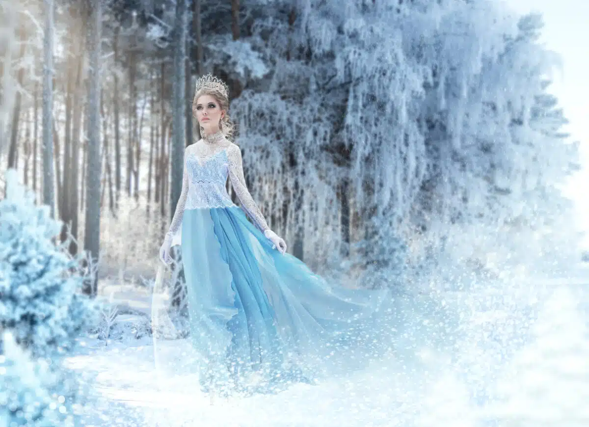 Beautiful young woman in fairy tale winter forest