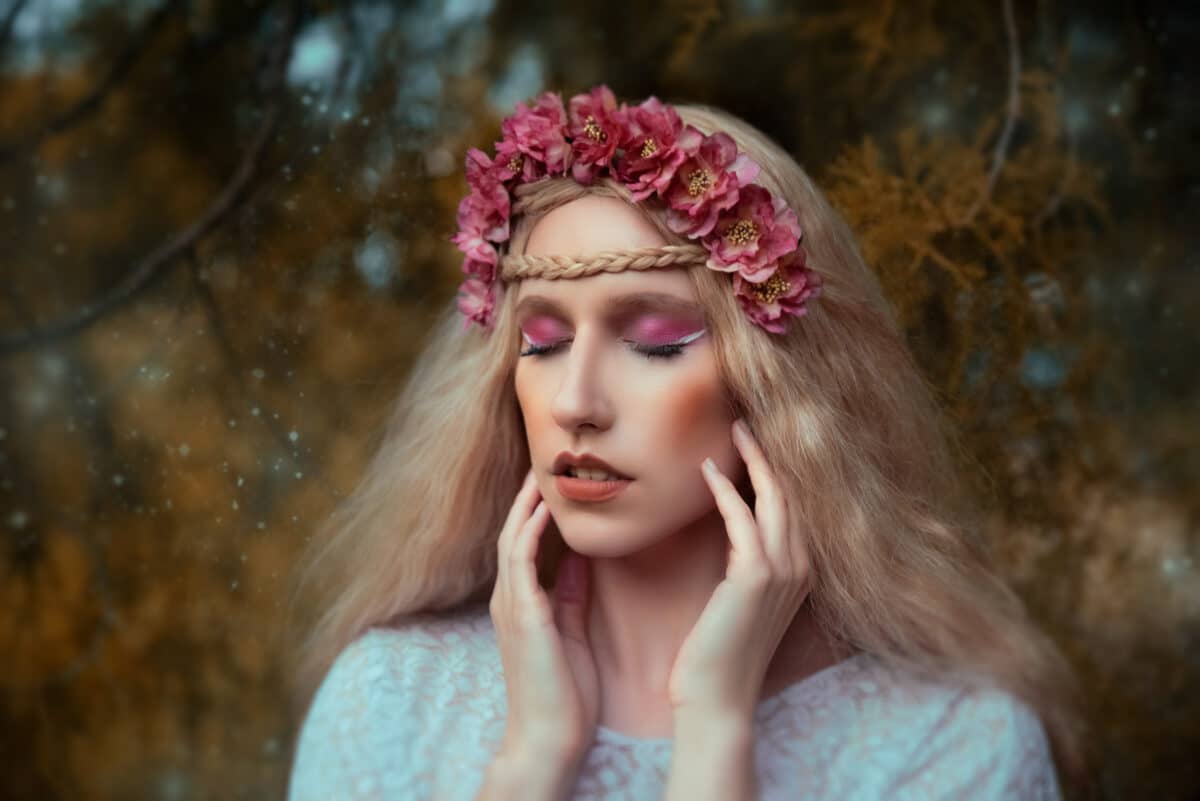 Young blonde woman wearing flower crown outdoors