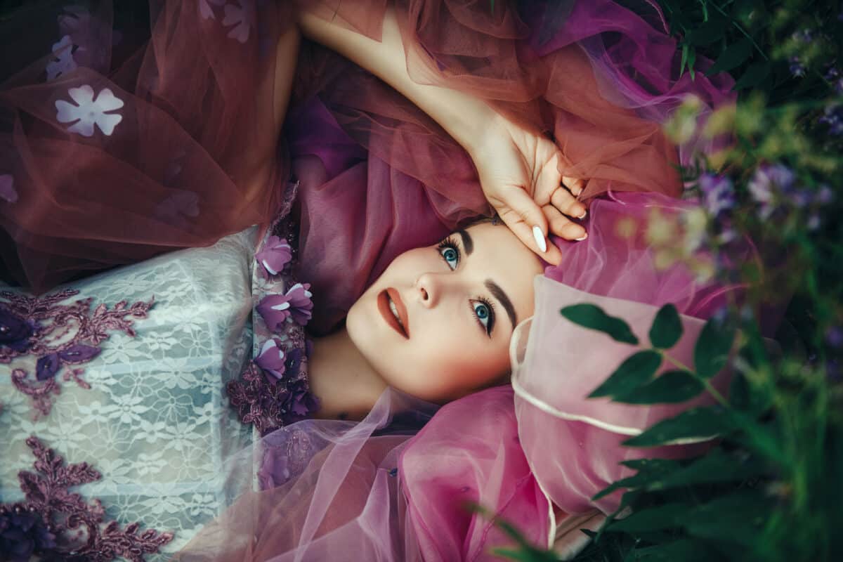 Beautiful model is emotionally posing with flowers