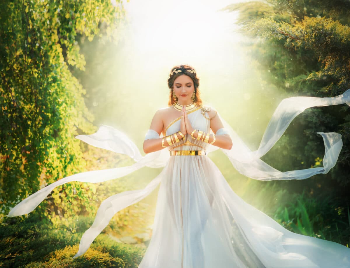 Fantasy queen dressed in white with hands clasped in prayer