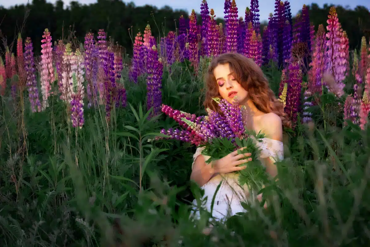 a lovely lady in white among the purple flowers in the field