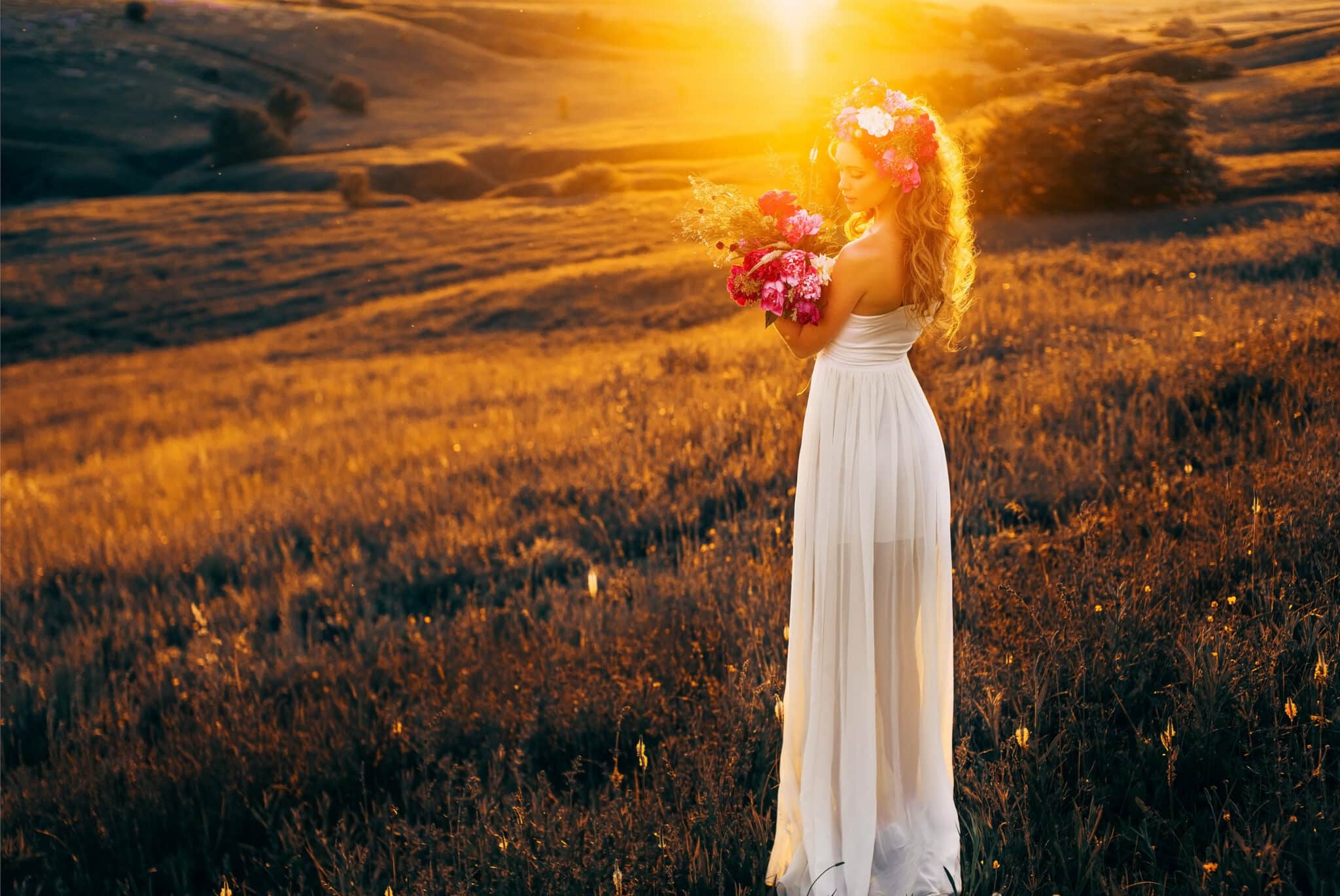 beautiful lady in white dress with a bouquet of peonies at sunset