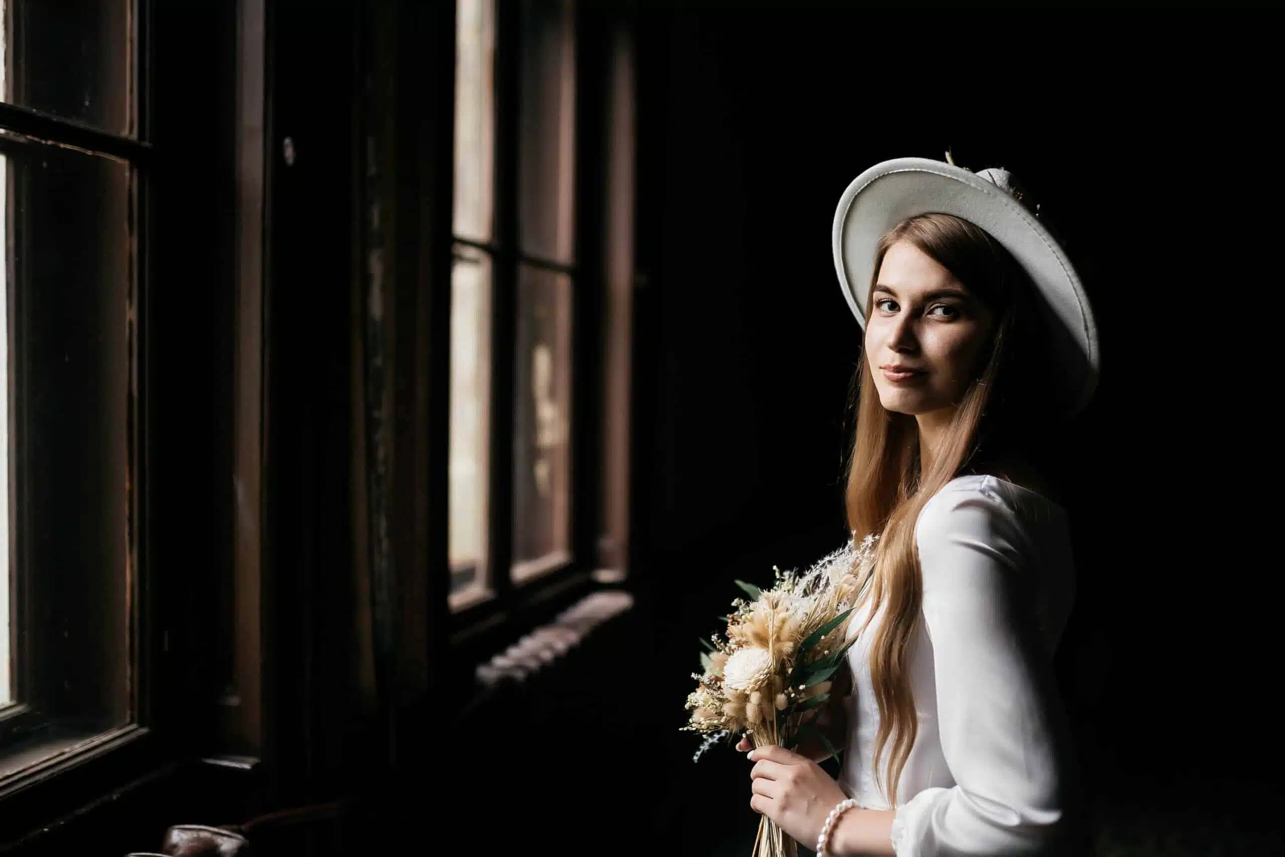 The bride in a hat and a bouquet. 