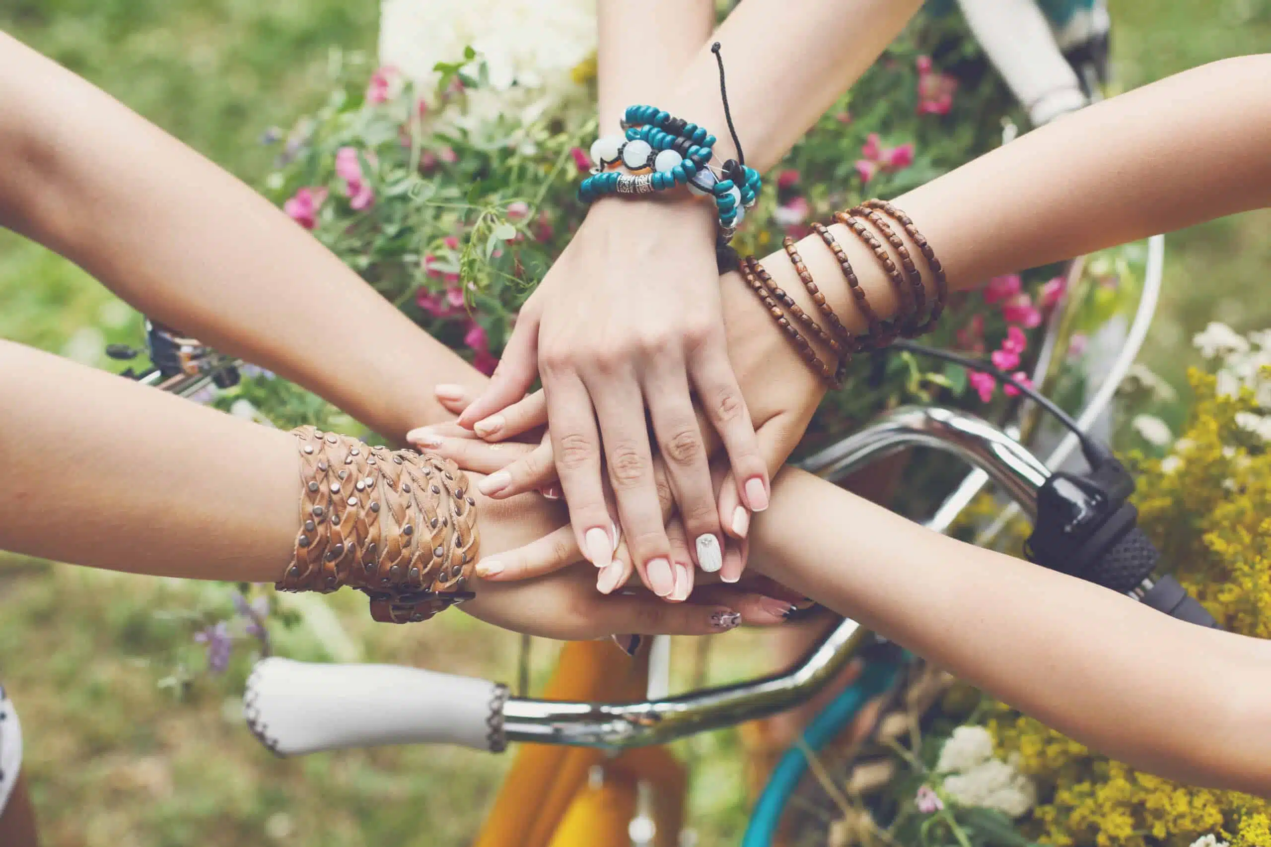 United hands of female friends outdoor