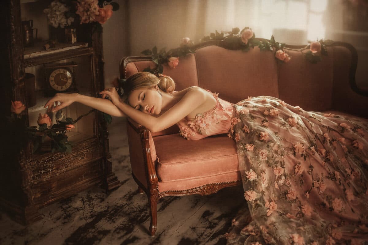 Tale of Sleeping Beauty. The girl is in the old, abandoned room. It covered the dust and roses. Summer atmosphere of sadness.