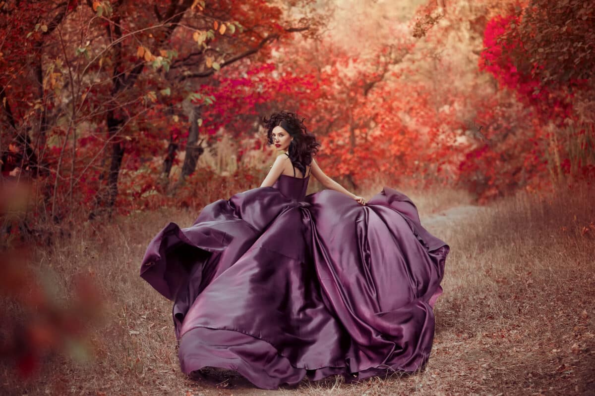 Lady in luxury lush purple dress runs in red wood ,fantastic sho