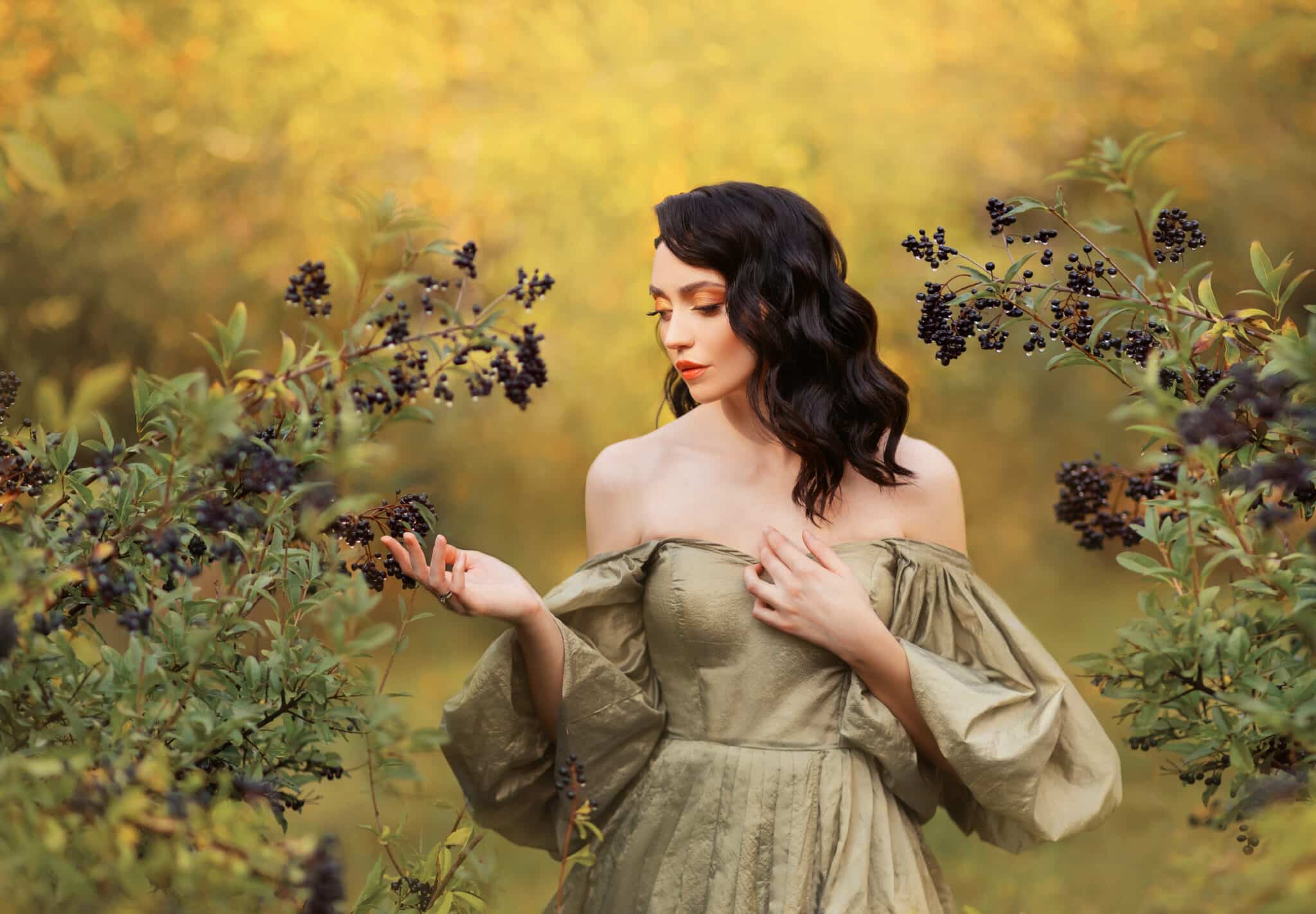 Romantic lady fantasy girl princess touches ripe wet black berries. Art photo, portrait of woman queen walking in autumn nature. Medieval dress vintage old style bare sexy off shoulder puffed sleeves.