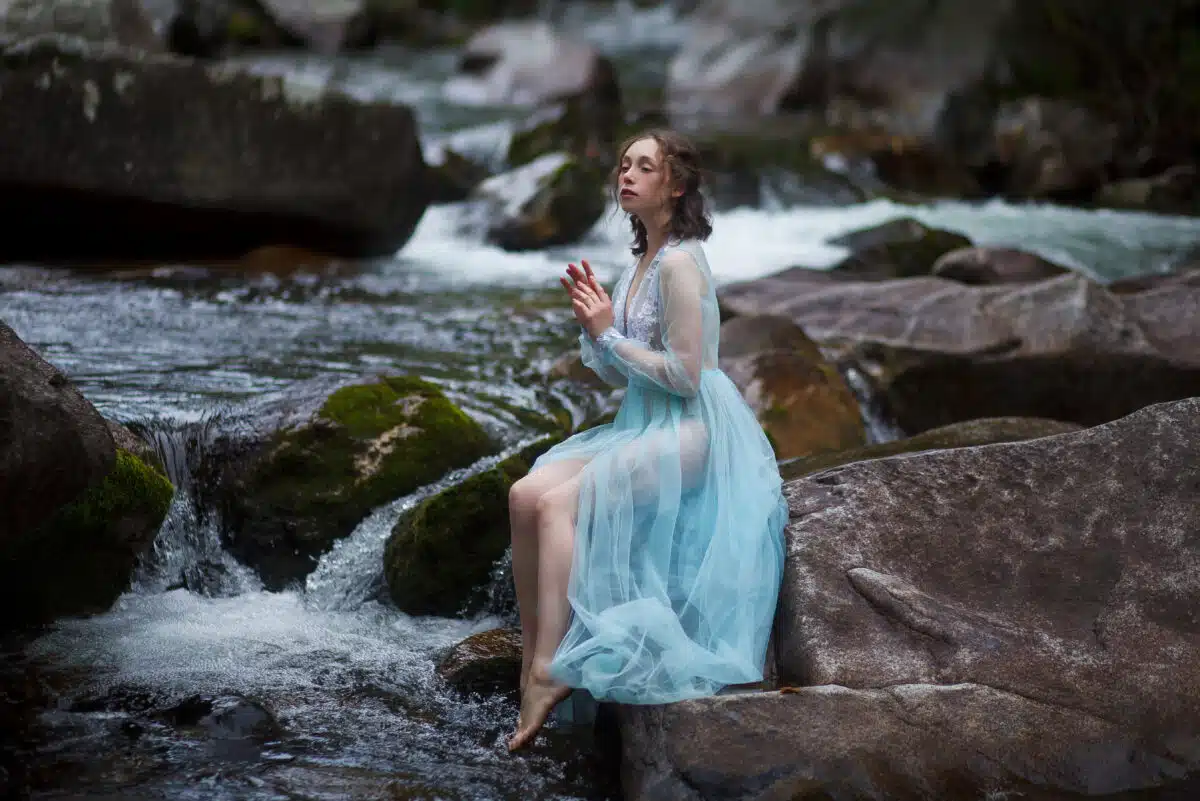 The Tale of the Mermaid. Tale of the River Nymph. Girl in a blue dress by the river.