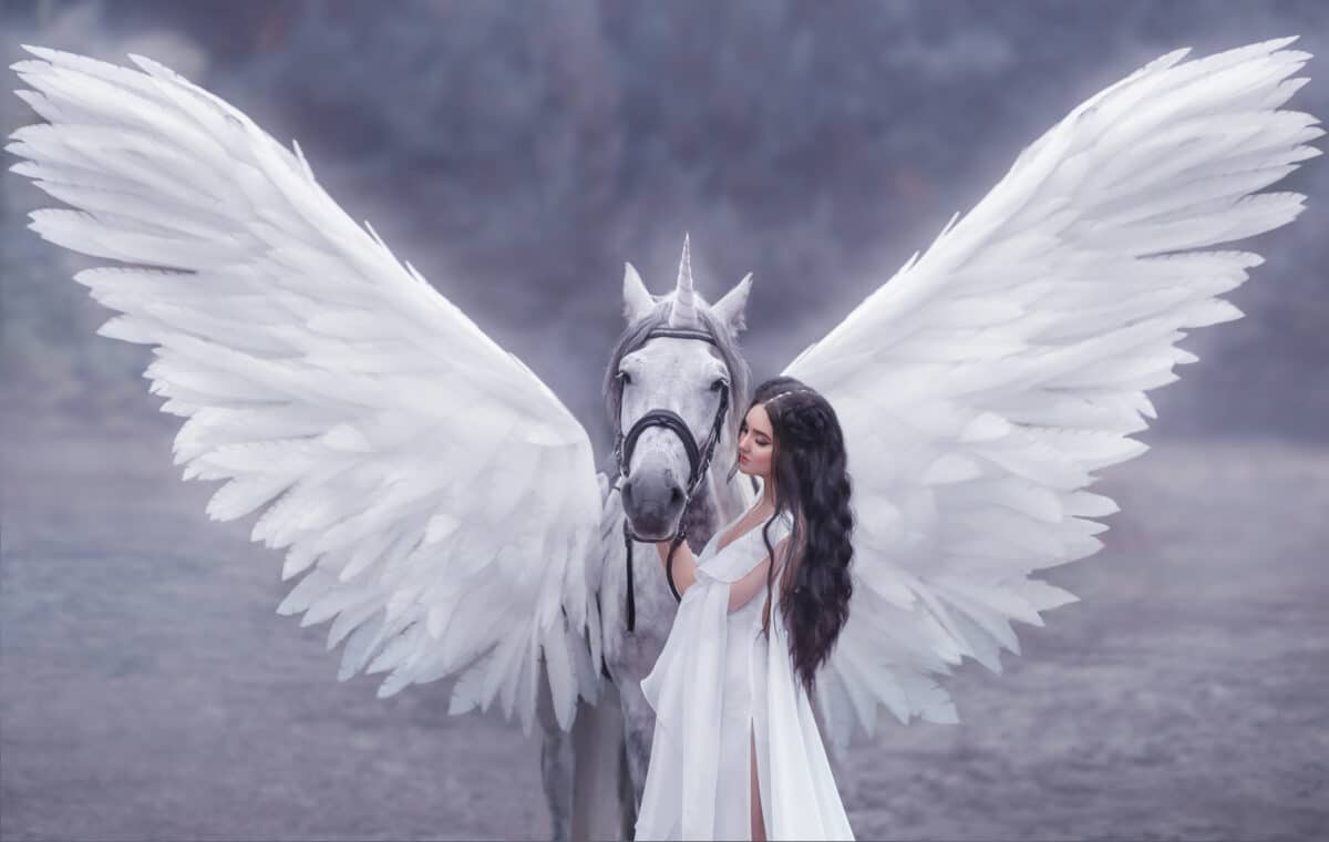 Beautiful, young elf, walking with a unicorn. She is wearing an incredible light, white dress. Art photography