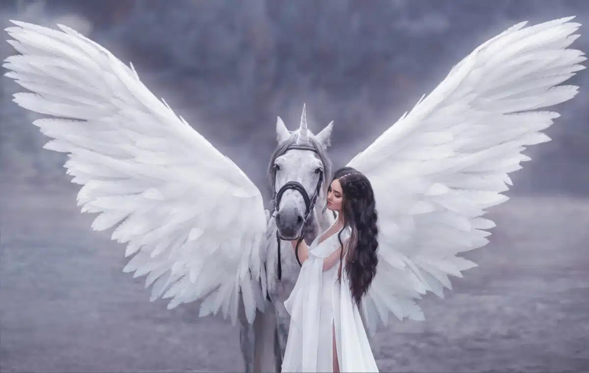 Beautiful, young elf, walking with a unicorn. She is wearing an incredible light, white dress. Art photography