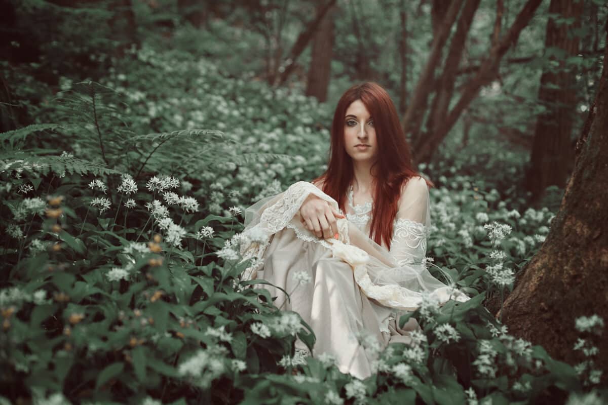 Beautiful red haired girl in secret forest