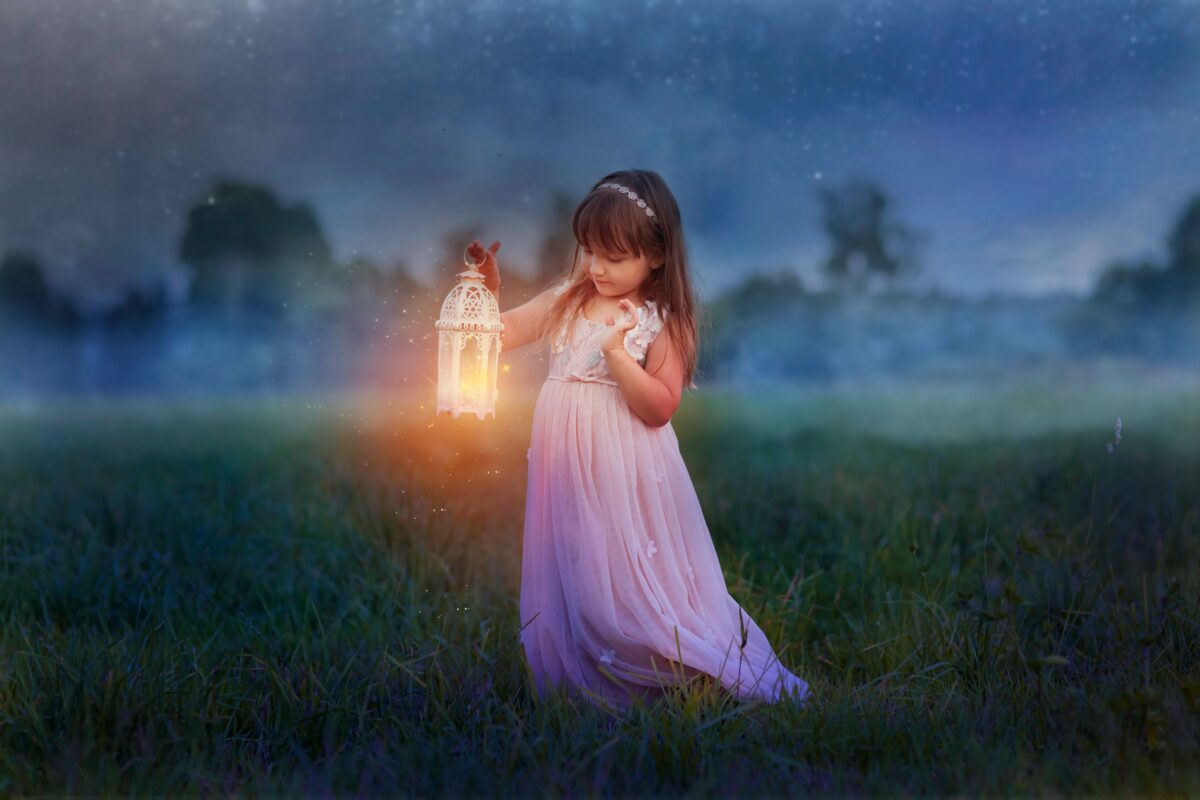 fantasy little girl holding a lamp while walking in the meadow at night