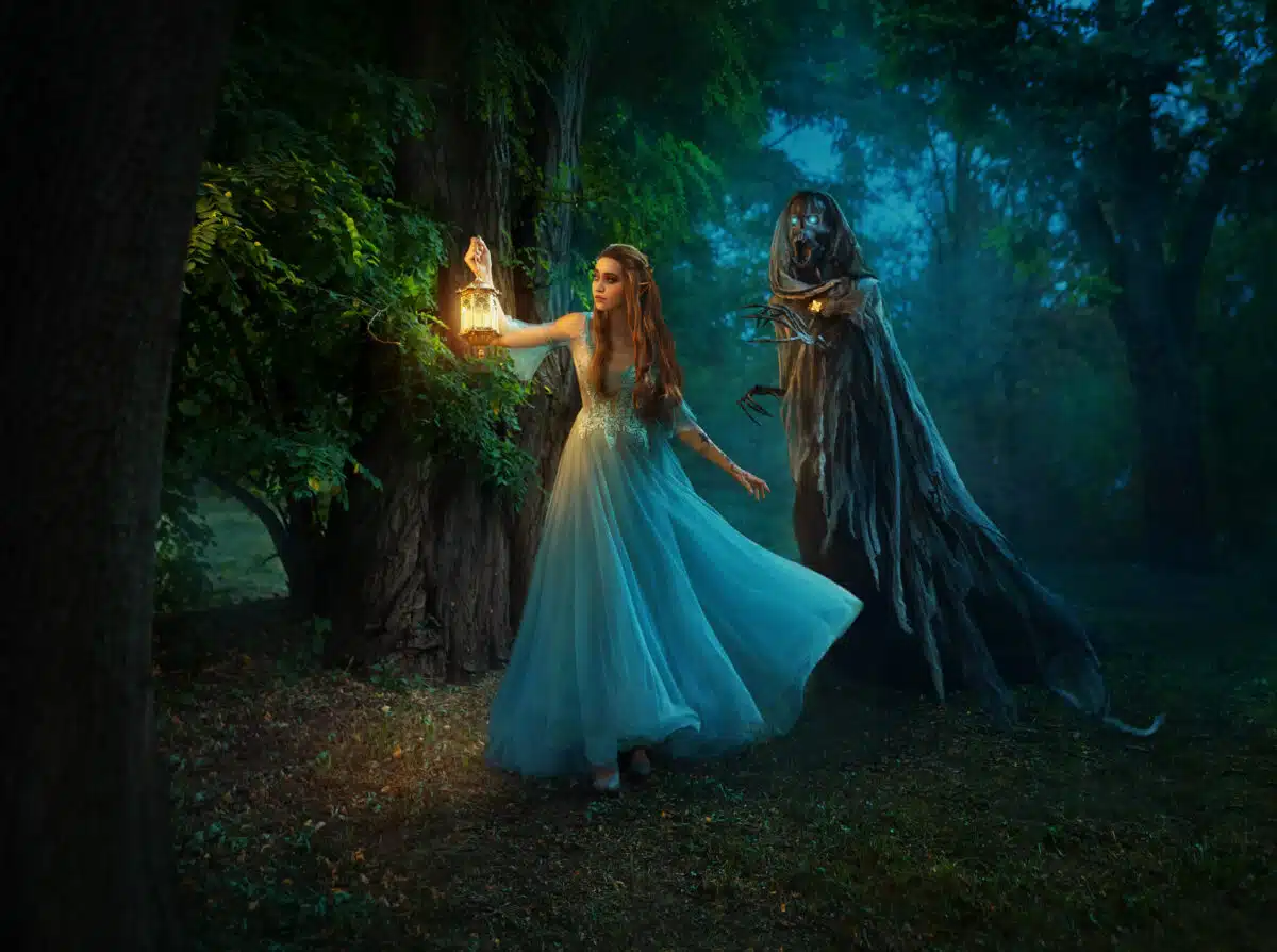 Fantasy woman elf walks in night forest, holding lantern in hands. Girl is hunted by dark fairy demon, ghost of Death, black skeleton in cloak hood. Cosplay of character from book of Feyre and Suriel