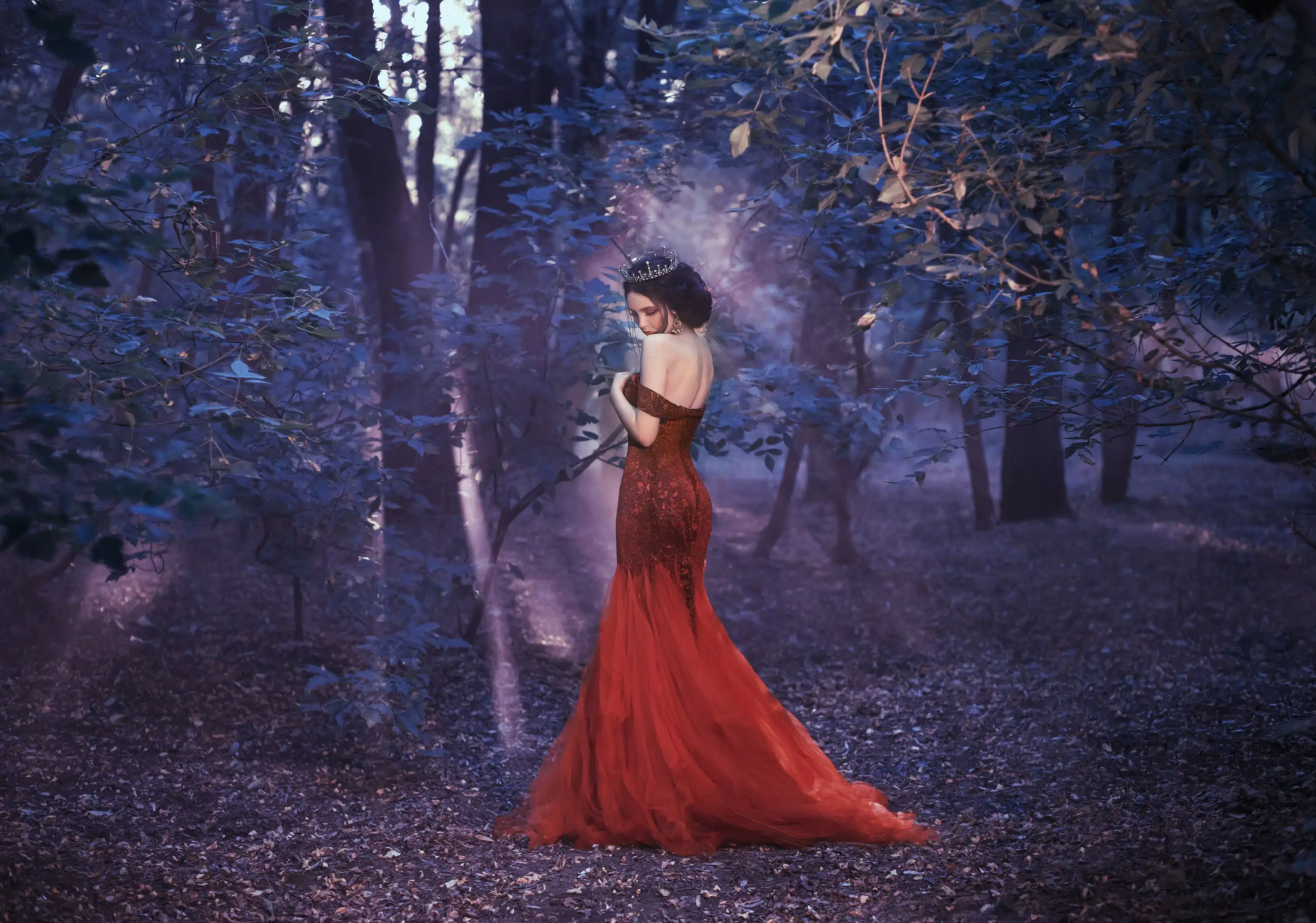 Attractive girl in a red dress. Walk in the fairy forest.