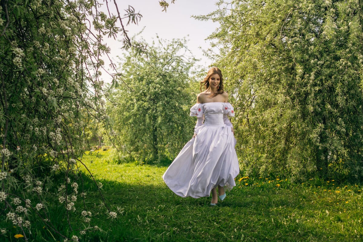 Princess walking in flowering garden