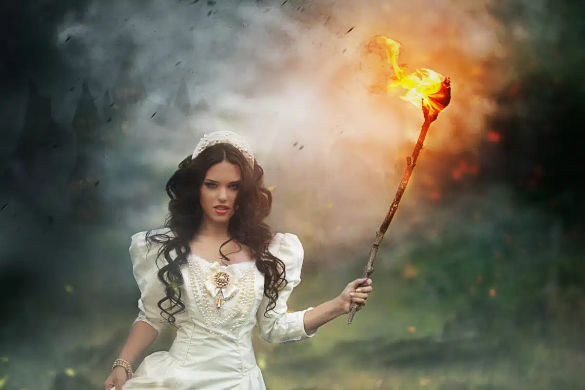 mystical photo. beautiful girl with a burning torch out of the w