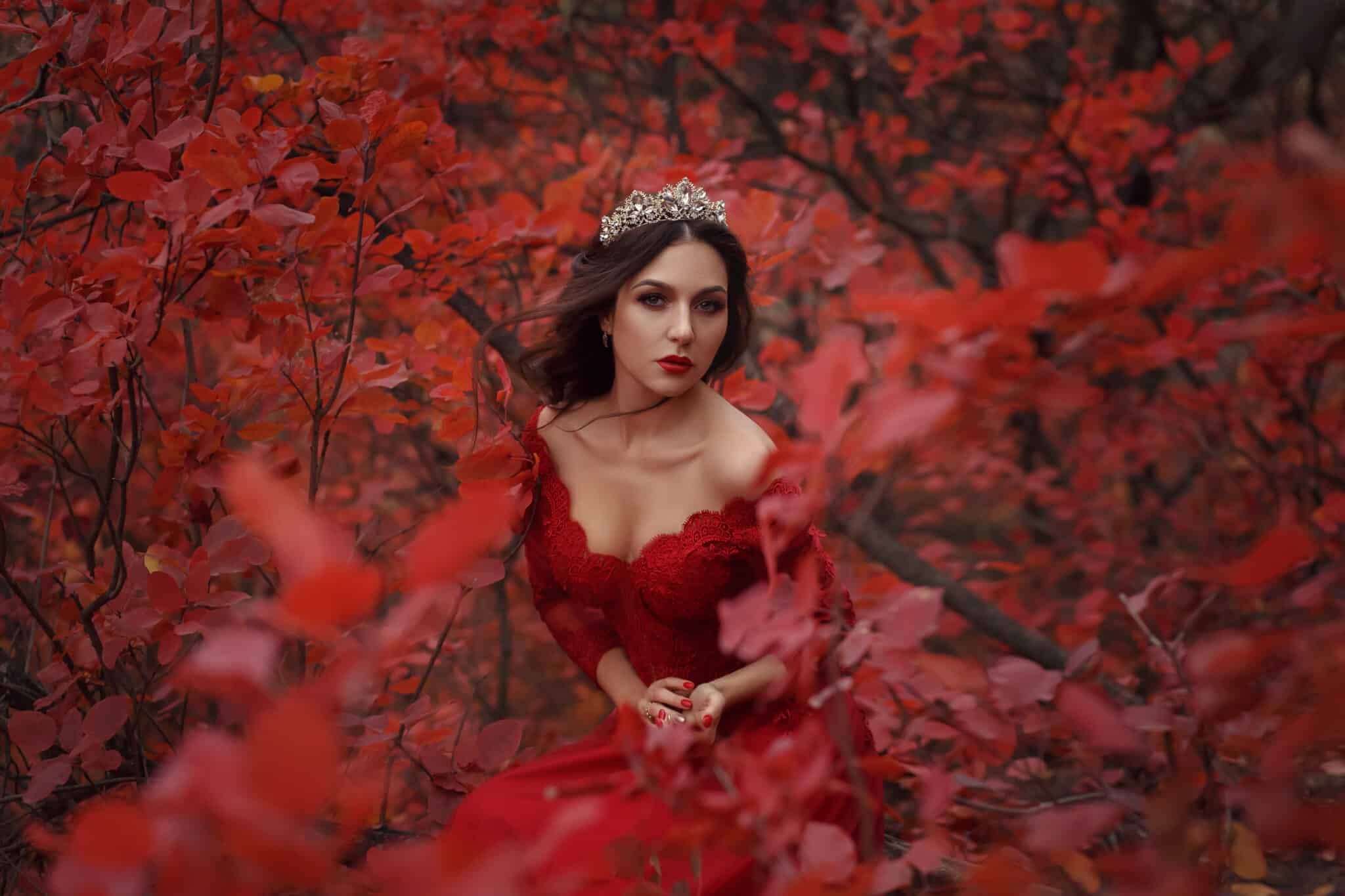 Incredible stunning girl in a red dress. The background is fantastic autumn.