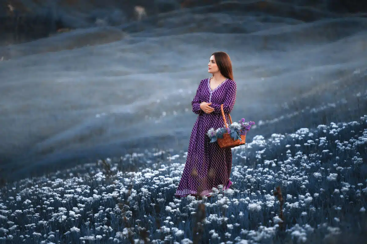 a woman on a field of blooming flowers