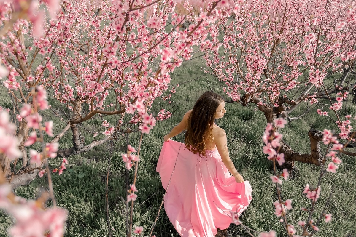 Beautiful girl in a blooming spring garden